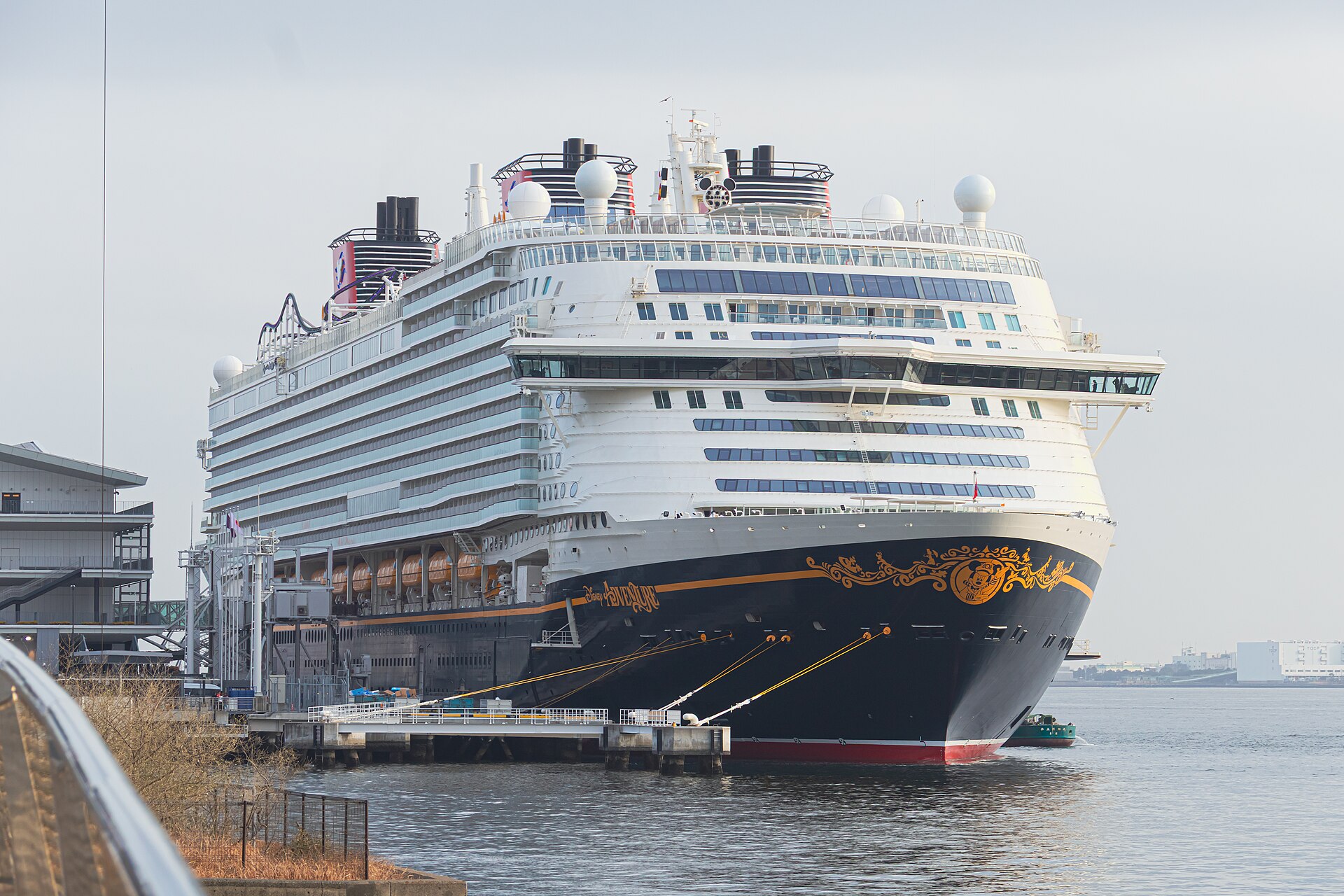 Disney Adventure docked at Tokyo International Cruise Terminal with its white superstructure and two red funnels