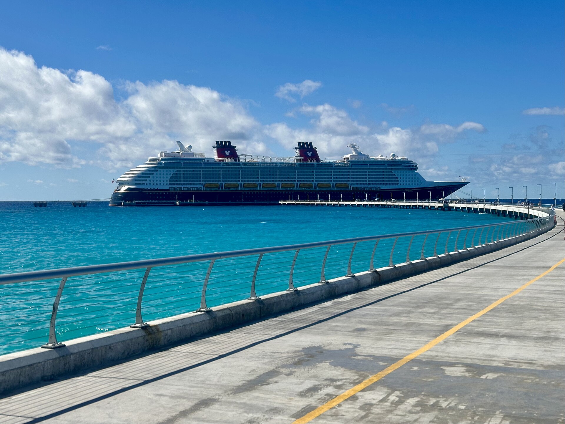 Disney Dream docked at Disney Lookout Cay with its white superstructure and red funnels visible